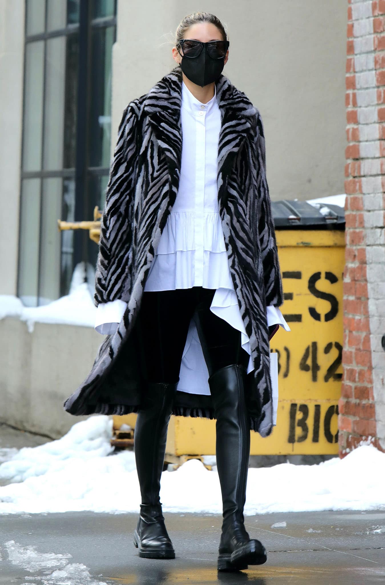 Olivia Palermo stays cozy in a Pologeorgis zebra-striped mink fur coat, white ruffled top, and leggings