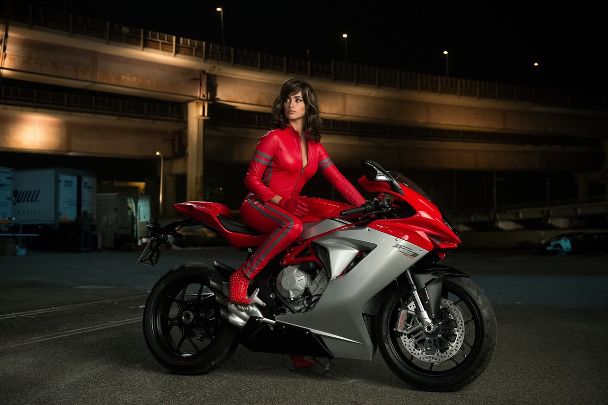 Penélope Cruz channels fierce moto-chic in a custom red Costume National jumpsuit and studded Christian Louboutin boots for her high-speed scenes in Zoolander 2