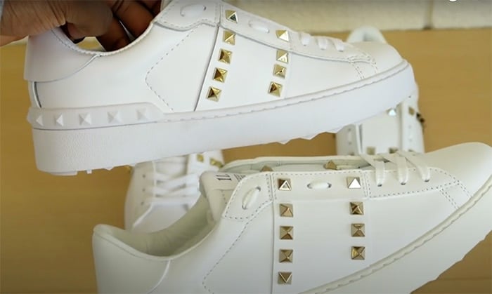 A screenshot from a Closer Look YouTube channel shows that the pyramid studs on the real Valentino shoes (bottom) are sharper and not as yellow as the studs on the fake Valentino shoes (top)