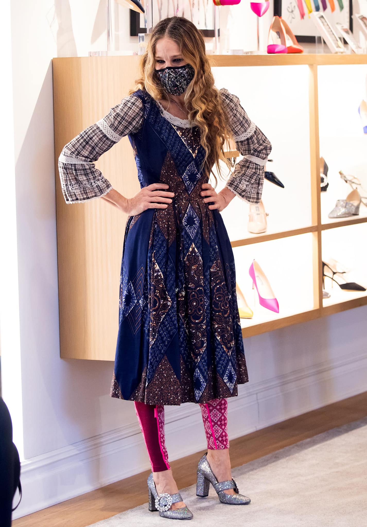 Underneath her coat, Sarah Jessica Parker wears a sleeveless paisley-printed dress with a prairie blouse and pink leggings