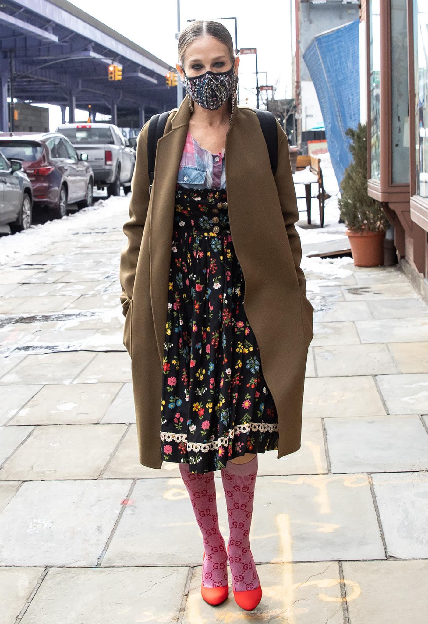 Sarah Jessica Parker bundles up in a tan coat outside her shoe store