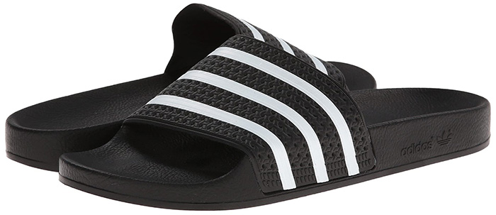 The classic Adidas Adilette slides, revered for their simplicity and comfort, bring an athleisure edge to fitted jogger looks