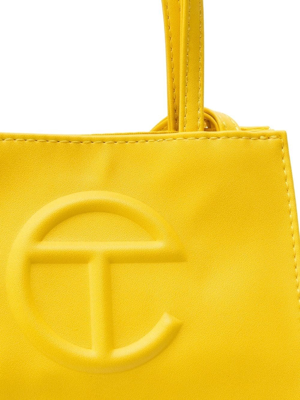 Yellow Telfar single shoulder strap tote bag with embossed front TC logo