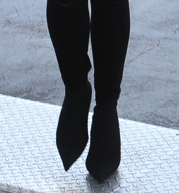 Chrissy Teigen wearing sock boots with black pants in 2017