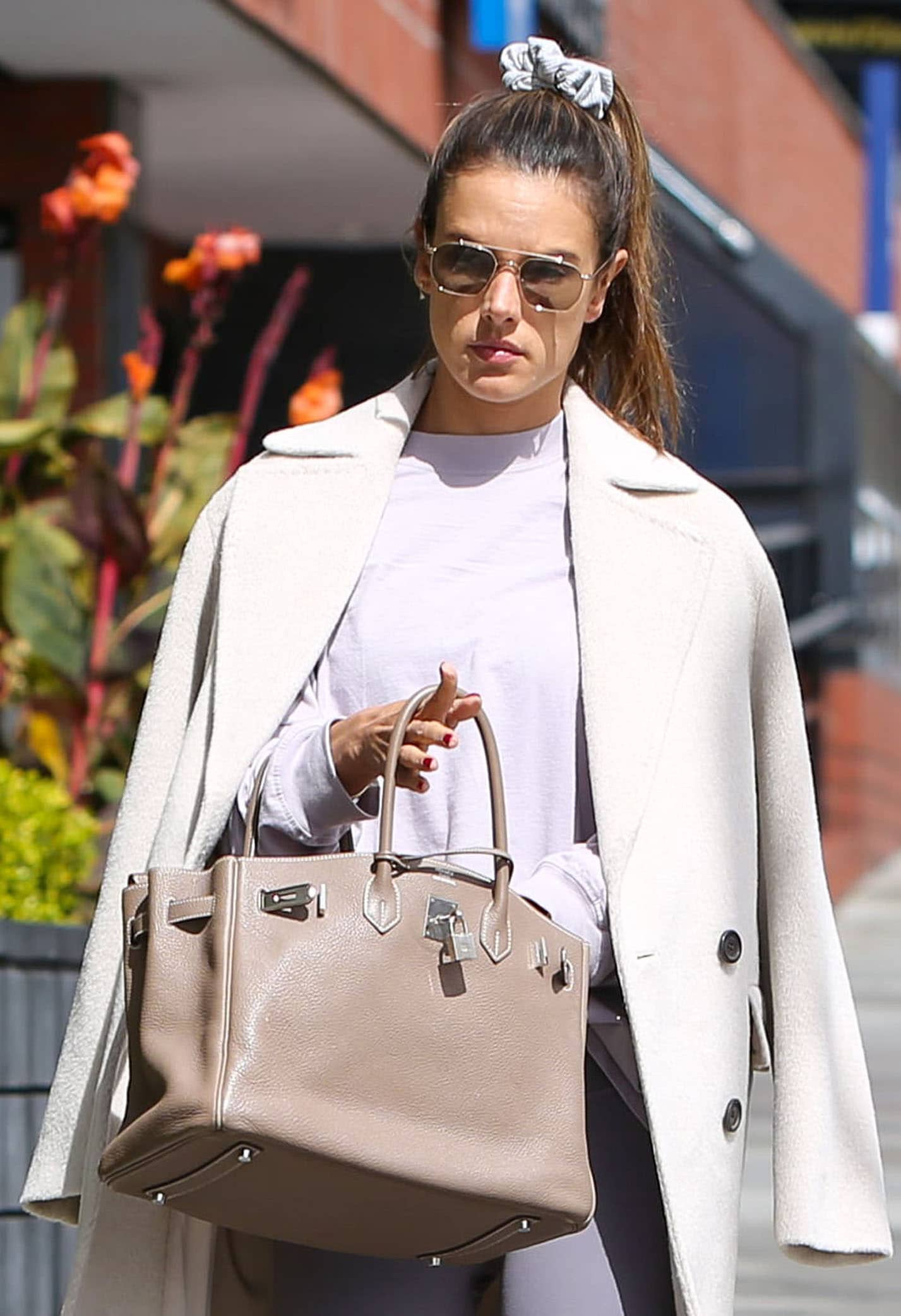 Alessandra Ambrosio wears a scrunchie and carries a Hermes Birkin bag in 35cm Etoupe