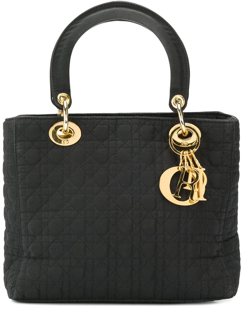 This black cotton and leather Lady Dior bag, handmade in France, epitomizes grace and style
