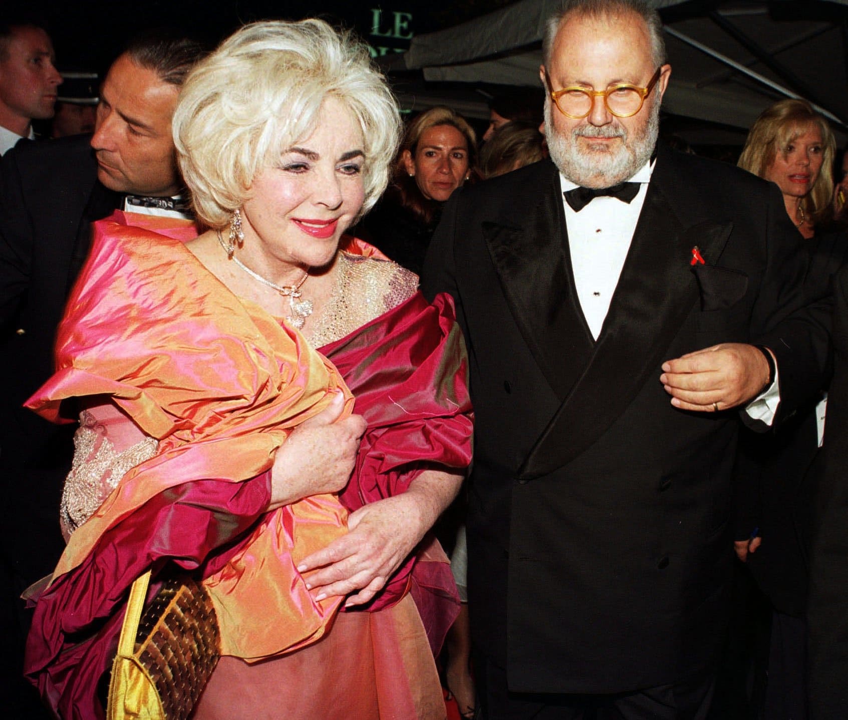 Italian fashion designer Gianfranco Ferré and Dame Elizabeth Rosemond Taylor DBE attend the amfAR Gala Cannes in 1999