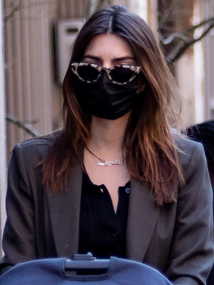 Emily Ratajkowski wears a pair of Eleventh Hour sunnies and a personalized gold necklace with her son's name "Sylvester"