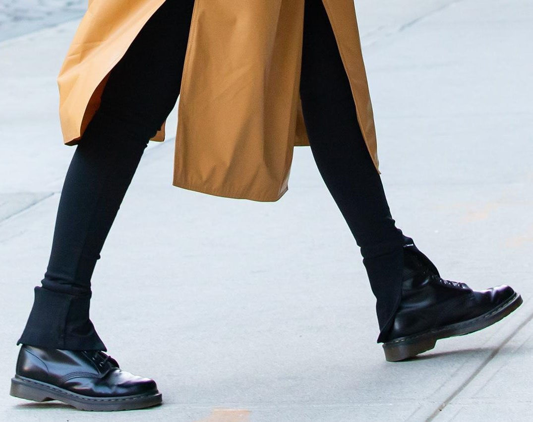 Gigi Hadid teams her coat and leggings with Dr. Martens 1460 boots