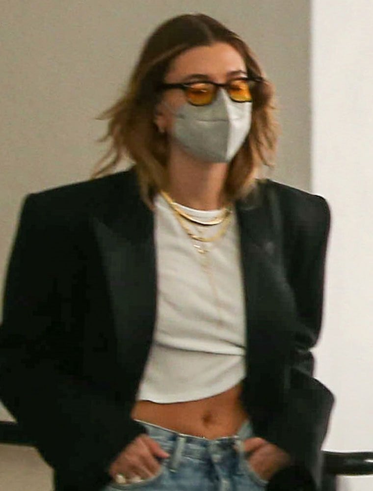Hailey Bieber accessorizes with Odessa1919 sunnies and a Kaze face mask