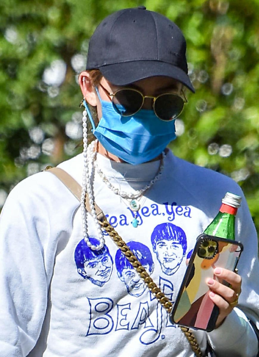 Lucy Hale keeps a low profile with a baseball hat, a face mask, and a pair of Paradigm sunglasses