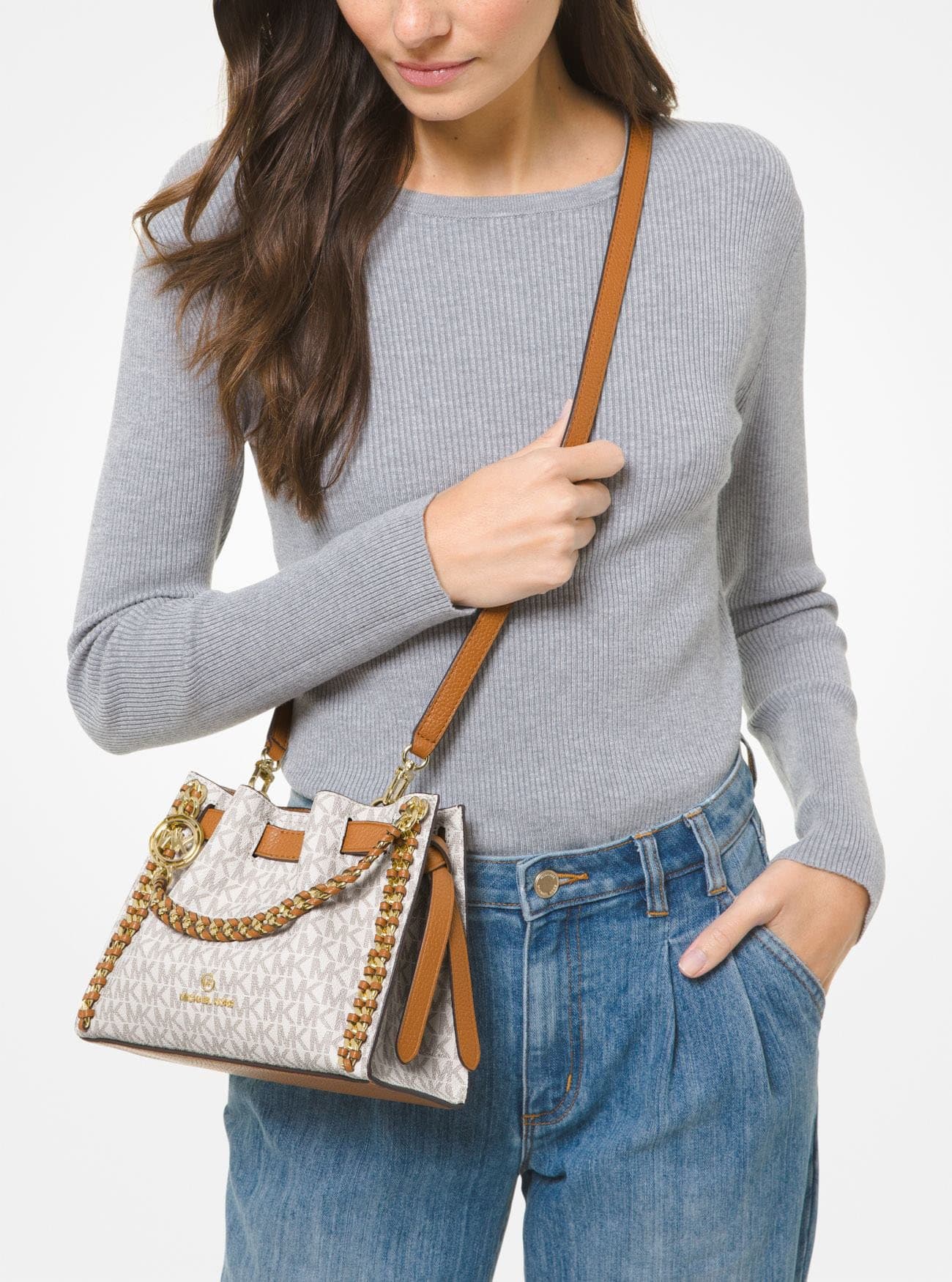 Carry it using the braided leather-and-chain top handles or the adjustable crossbody strap