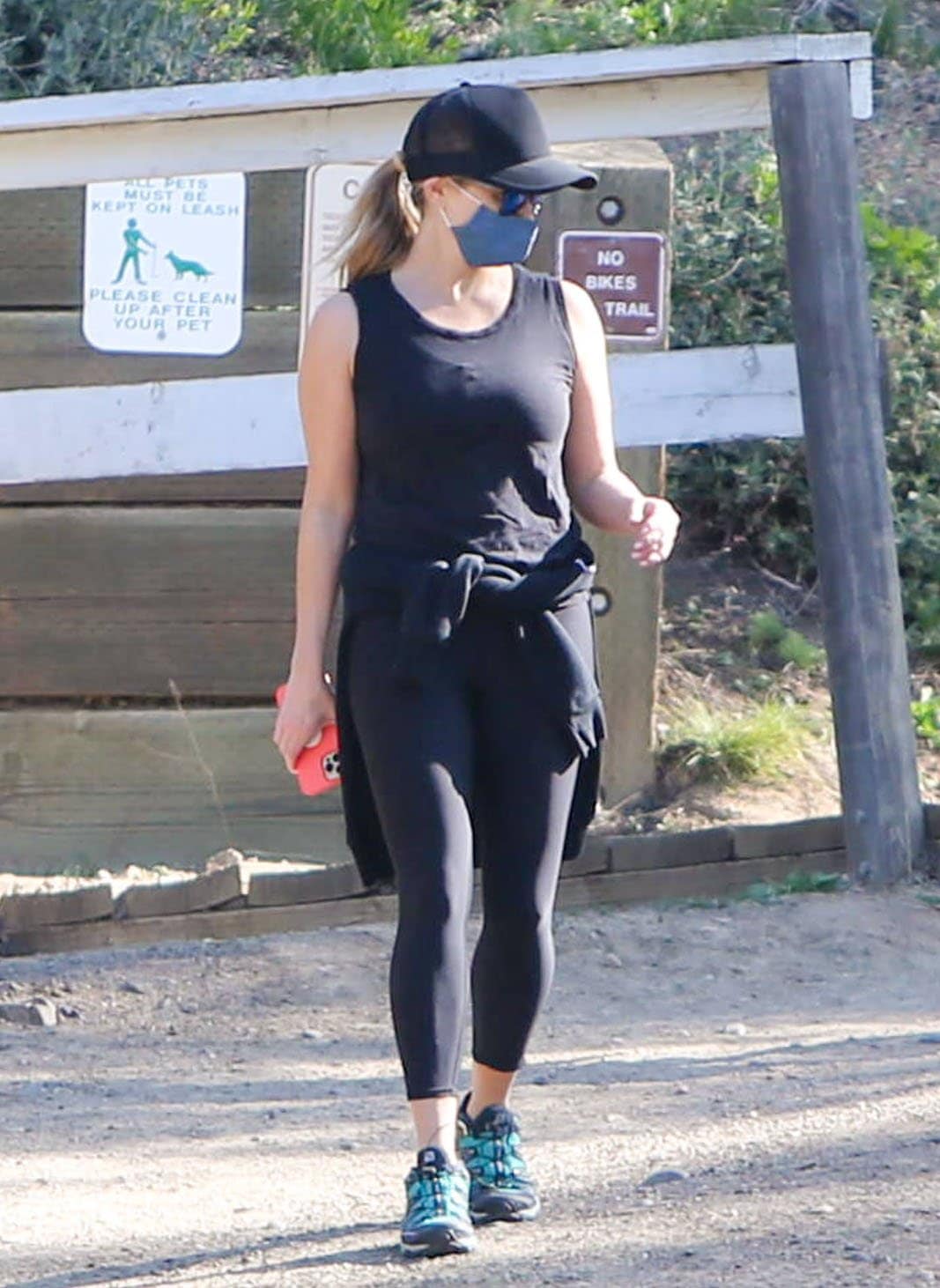 Reese Witherspoon keeps a low profile with a baseball cap, Oakley sunnies, and a Draper James face mask