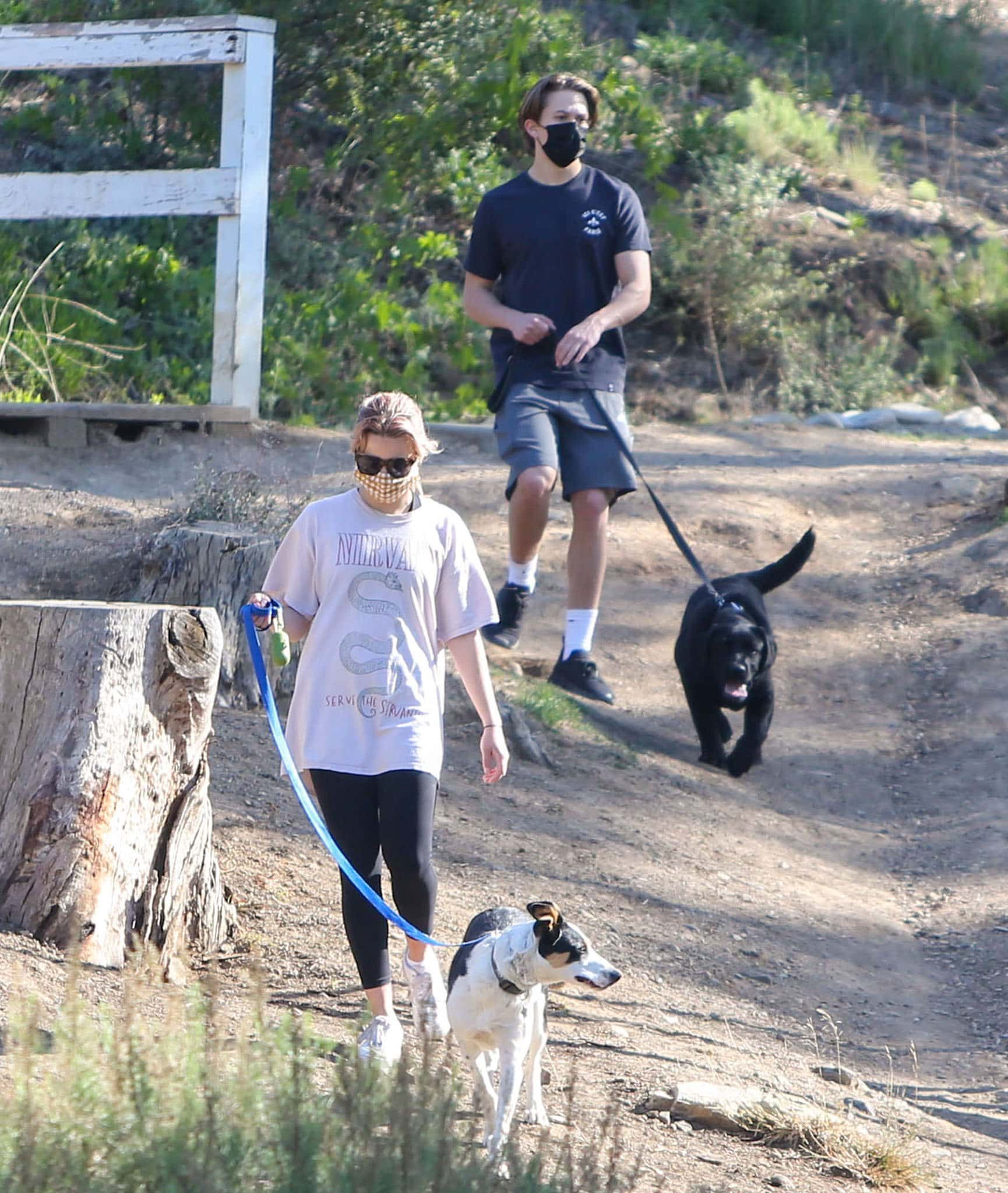 Deacon, 17, goes hiking in gray shorts and a black tee, while Ava, 21, wears an oversized Nirvana tee with cropped leggings
