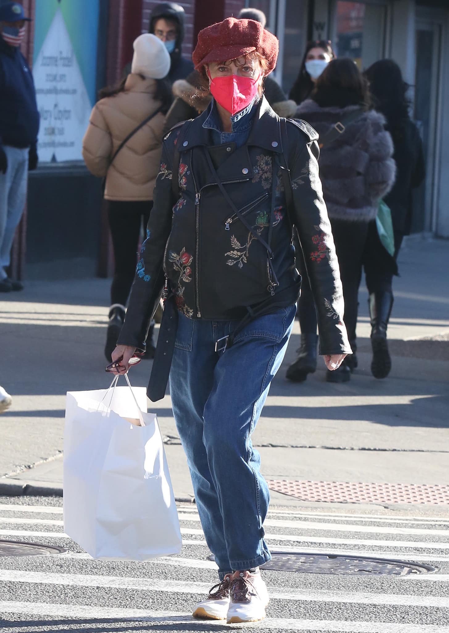 Susan Sarandon goes shopping in denim overalls and a floral moto jacket