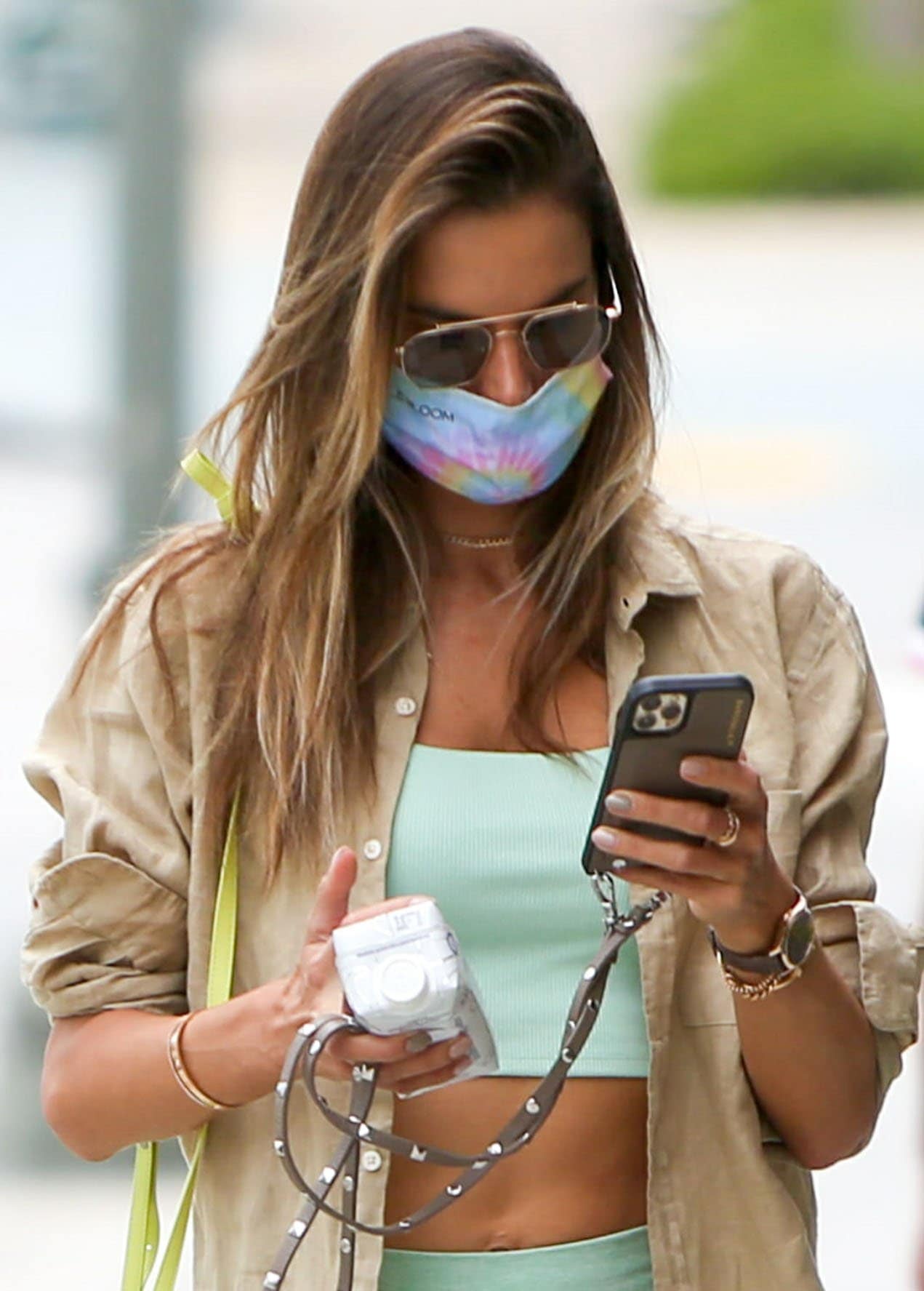 Alessandra Ambrosio stays safe from COVID-19 with a tie-dye rainbow face mask