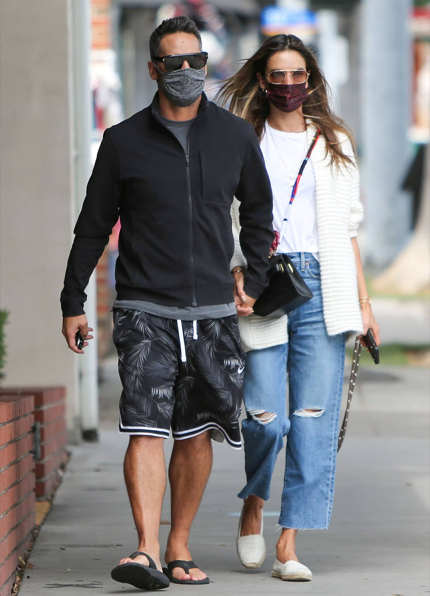 Richard Lee and girlfriend Alessandra Ambrosio hold hands while on a stroll in Los Angeles on April 21, 2021