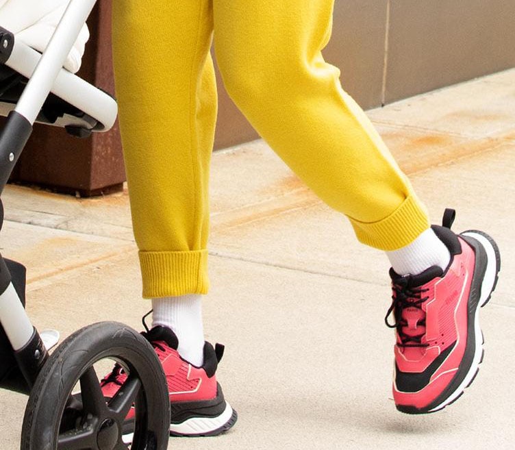 Gigi Hadid adds more color to her vibrant look with bold red Berluti Gravity trainers