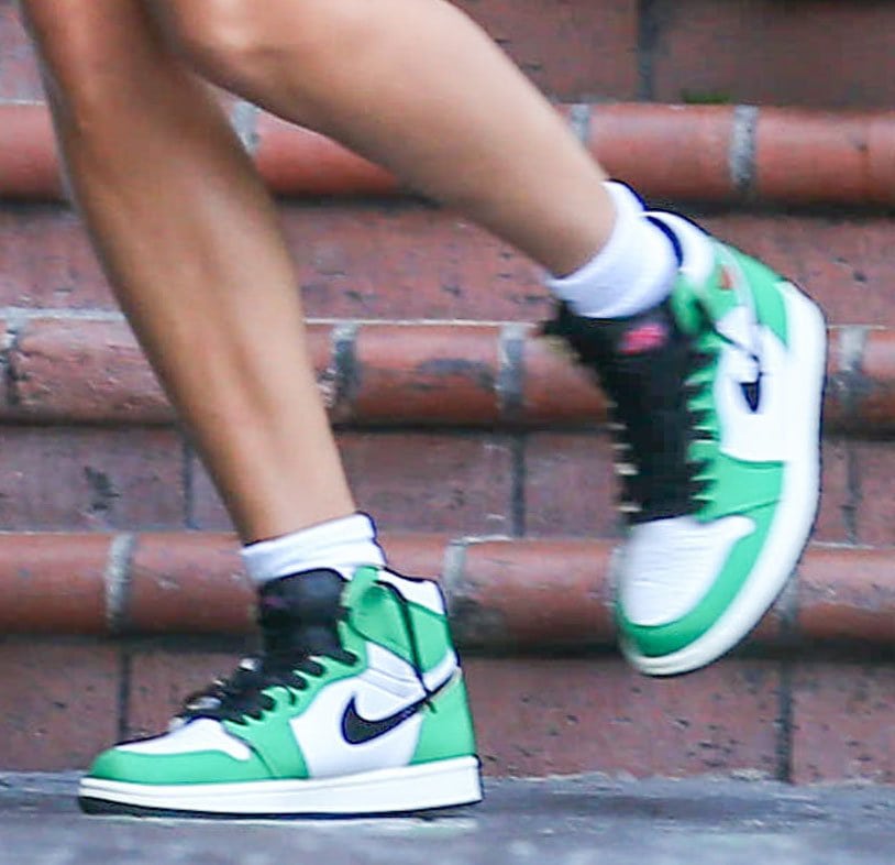 Hailey Bieber finishes off her street chic look with Air Jordan 1 Retro High OG in Lucky Green colorway