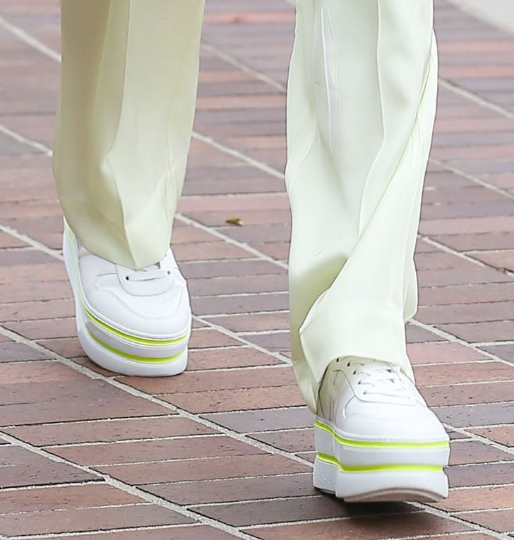 Heidi Klum dresses down her pantsuit with chunky white Hogan sneakers with neon striped trims