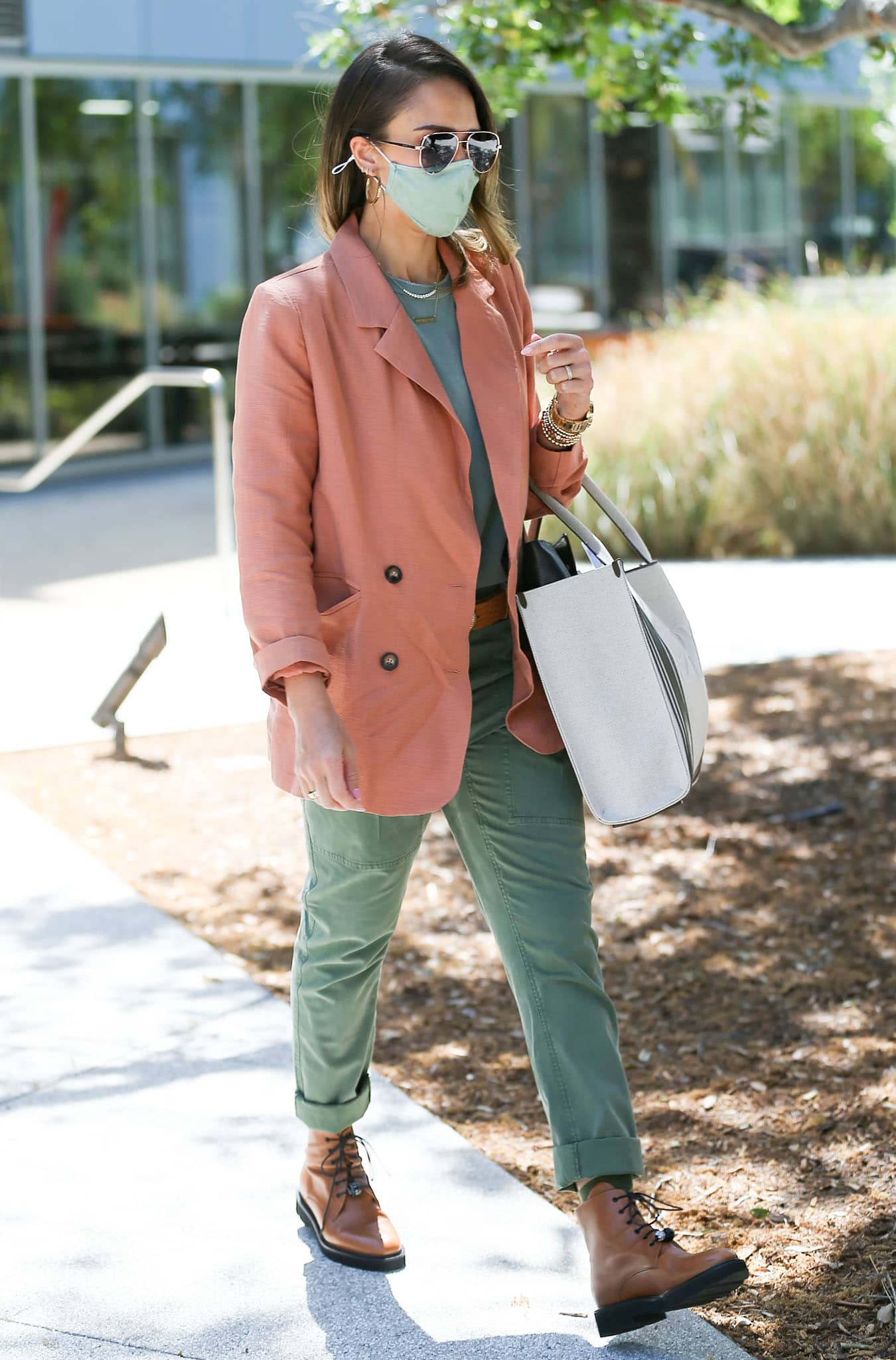 Jessica Alba defines spring-chic in sage green tee, green cargo pants, and peach blazer