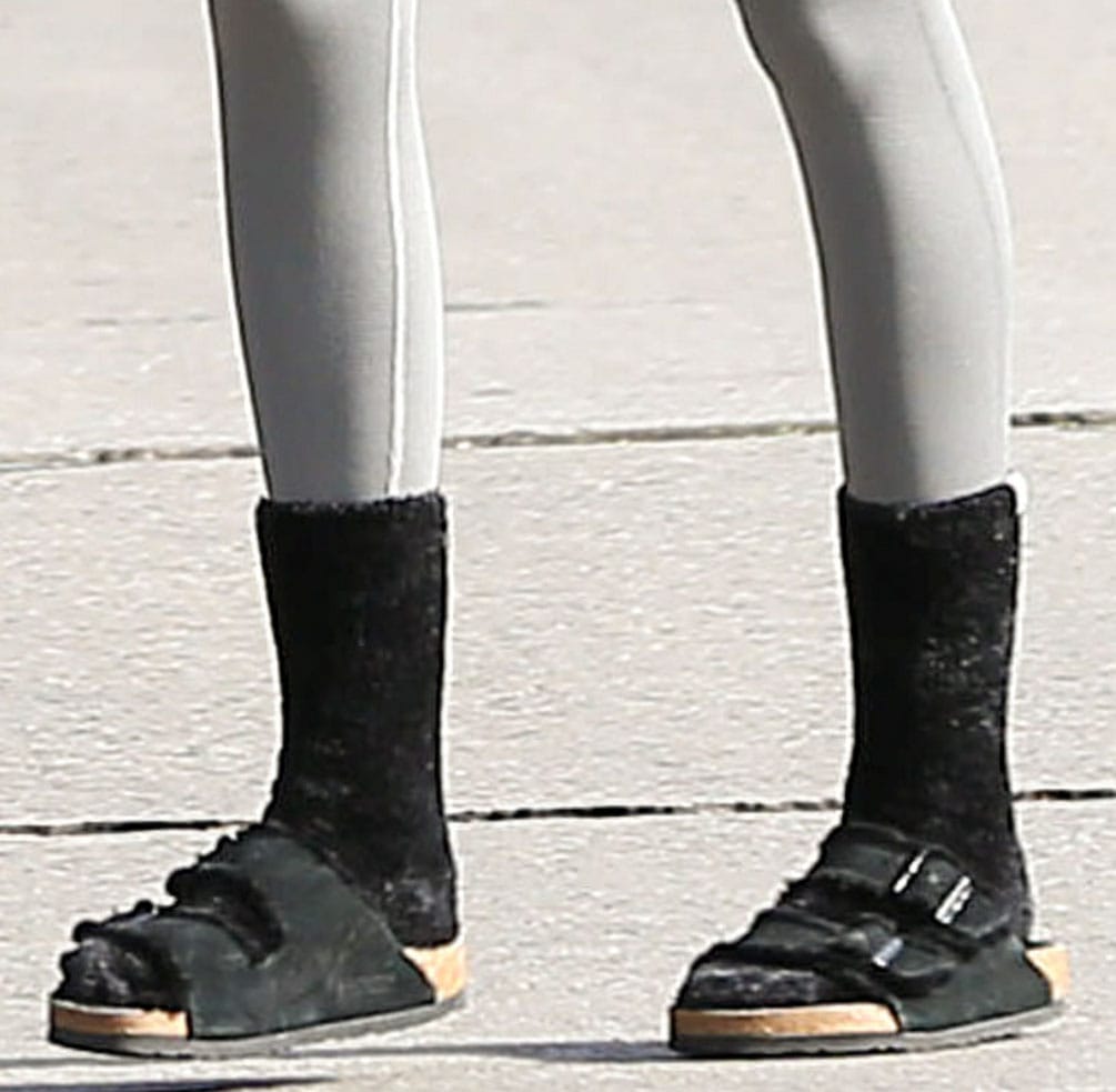 Kaia Gerber completes her Pilates outfit with UGG Leda cozy socks and Birkenstock fur Arizona sandals