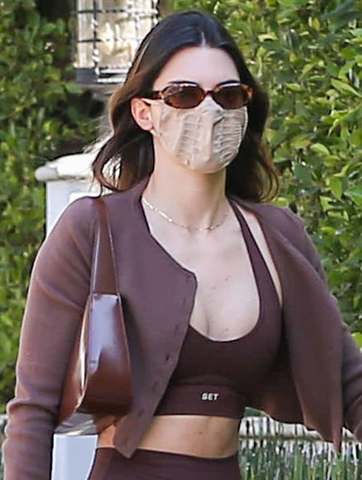 Kendall Jenner keeps things low-key with Dmy by Dmy sunglasses and a Skims face mask