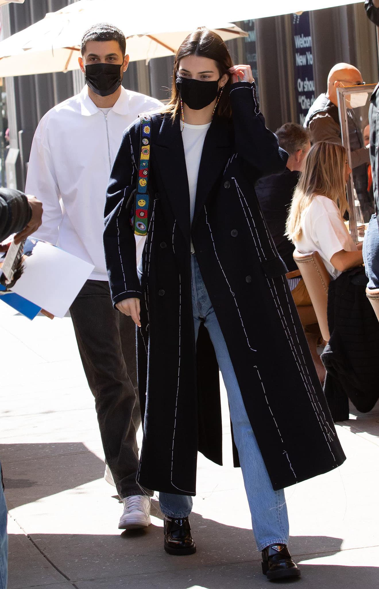 Kendall Jenner, pictured in a Rohk embroidered coat, Still Here jeans, and Prada leather loafers, is currently dealing with death threats and stalking incidents