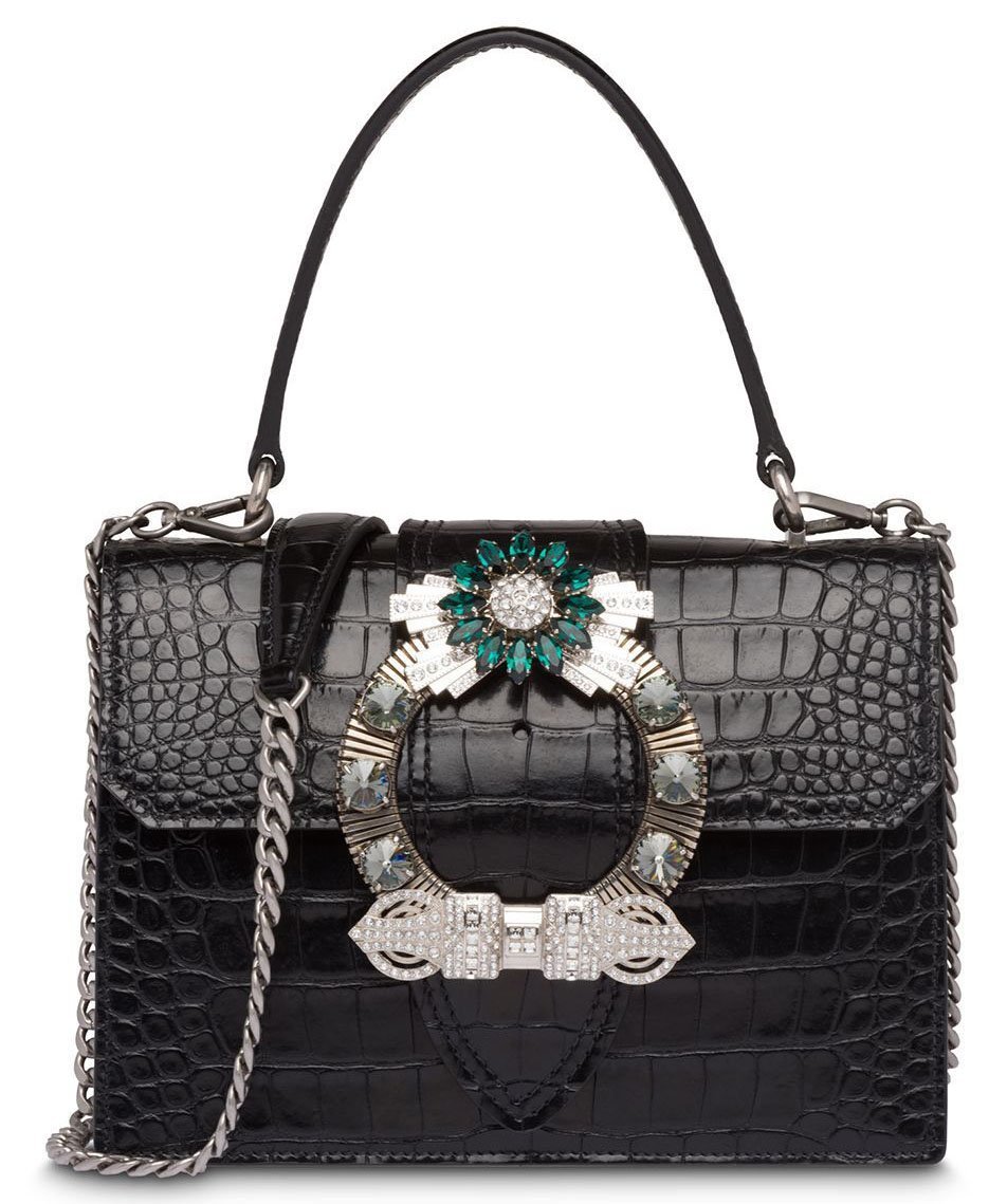 The Miu Miu "Miu Lady" bag is defined by the crystal buckle on the fold-over flap