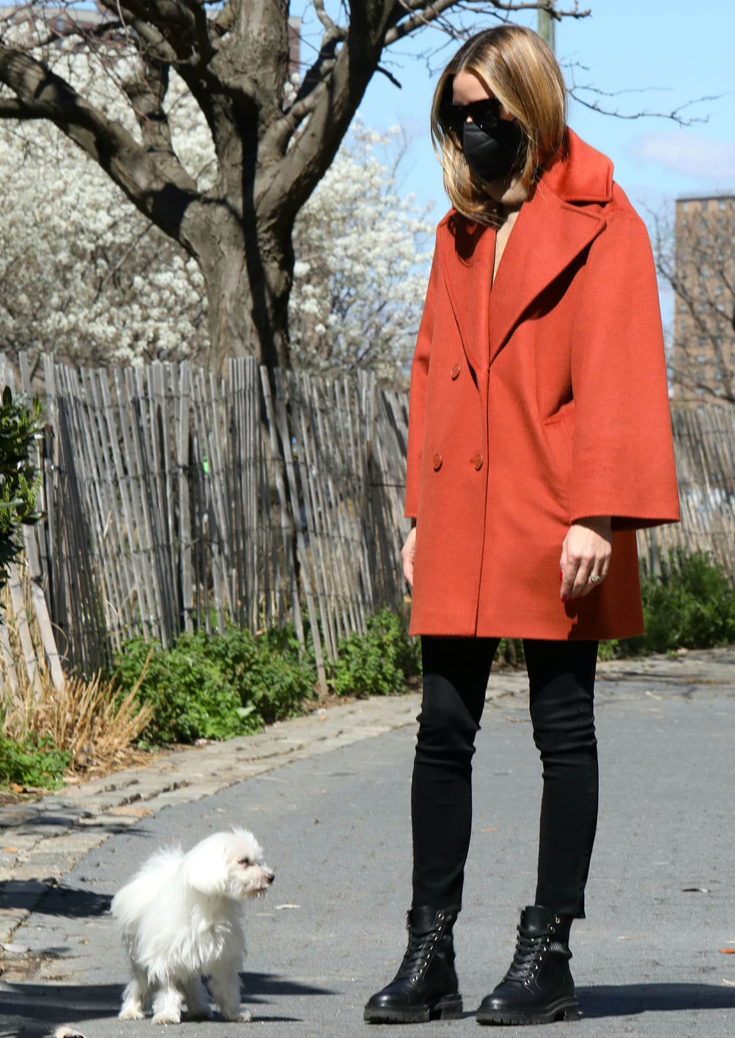 Olivia Palermo wears orange Max & Co. coat with camel sweater and black leggings