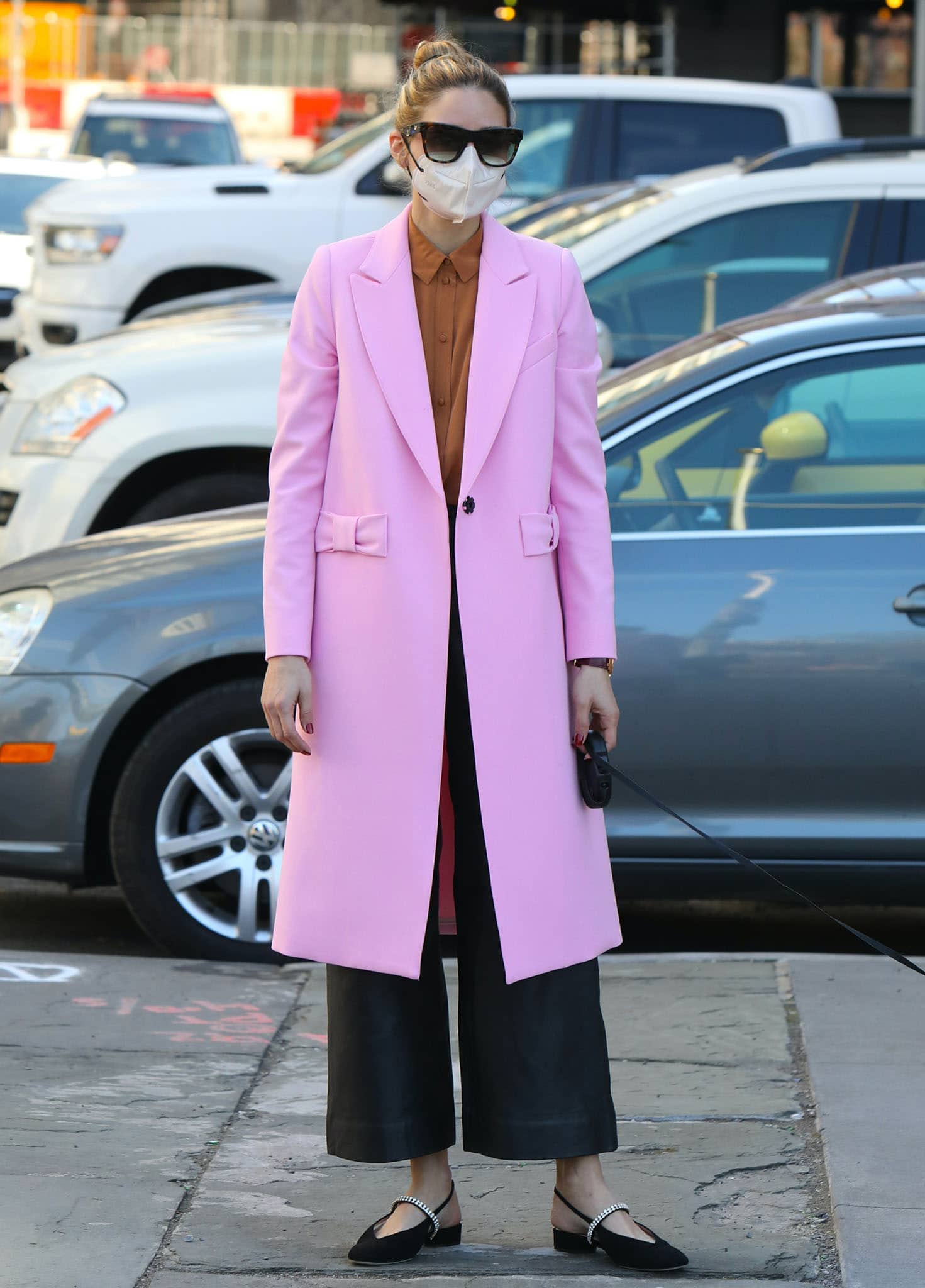 Olivia Palermo steps out in a feminine petal-pink Smythe bow coat and black wide-leg pants on March 30, 2021