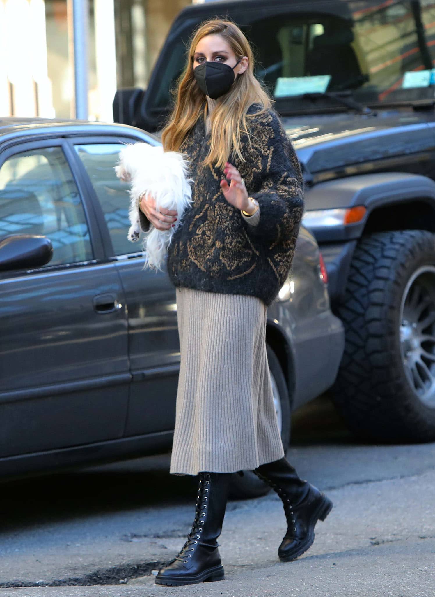 Olivia Palermo rocks a transitional spring outfit consisting of a rib-knit dress and a Brunello Cucinelli cardigan