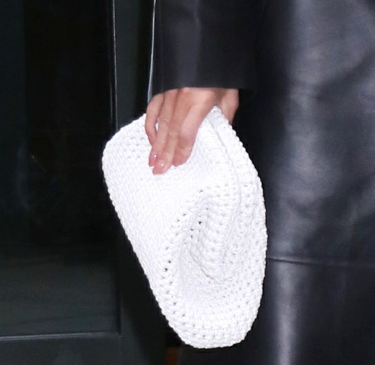 Rosie Huntington-Whiteley carries her essentials in a Bottega Veneta The Pouch handwoven crochet clutch