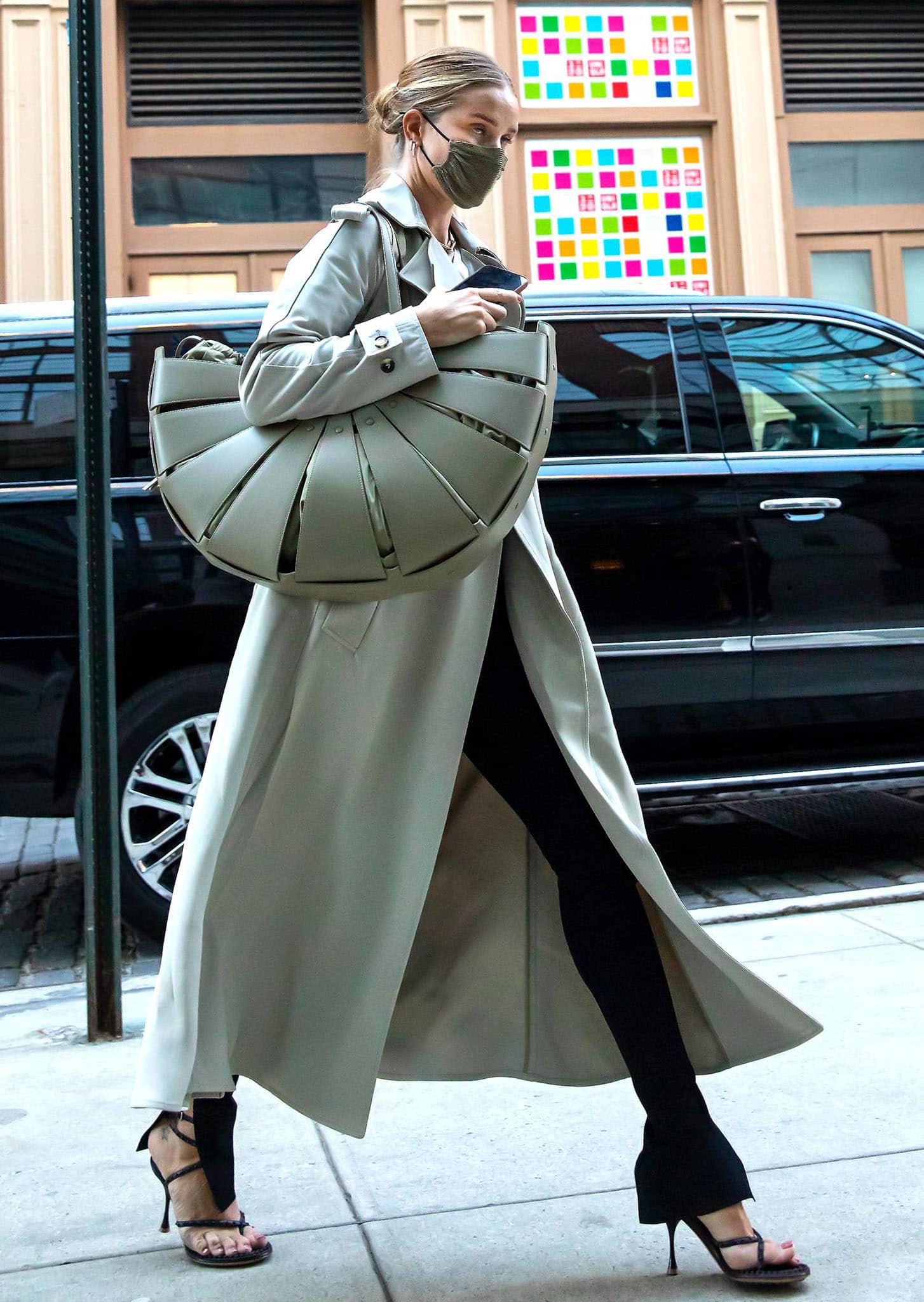 Rosie Huntington-Whiteley dons a Bottega Veneta trench coat with Toteme tee and The Row jeans