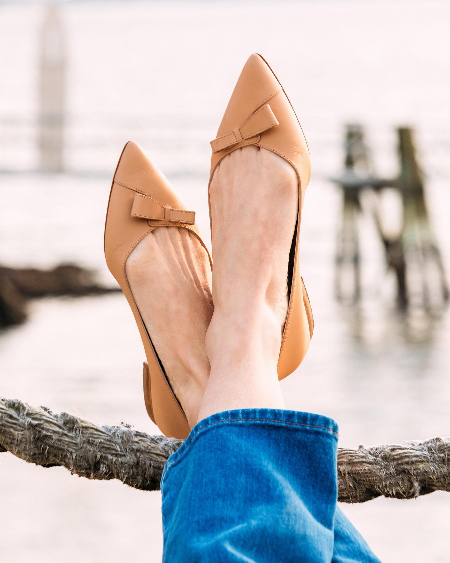 Sarah Flint's Italian-handcrafted Natalie flats provide luxurious comfort with a stylish asymmetrical bow and about 0.4-inch heels