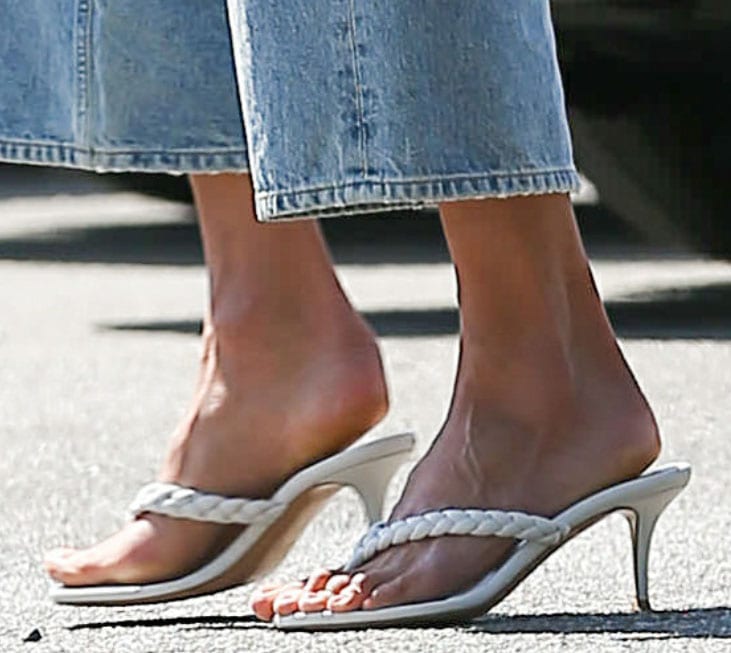 Alessandra Ambrosio displays her long feet in a pair of Gianvito Rossi braid thong sandals