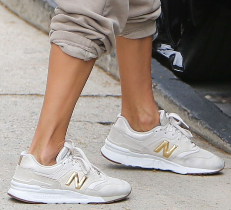 Alessandra Ambrosio pairs her athleisure with New Balance 997H white/gold shoes