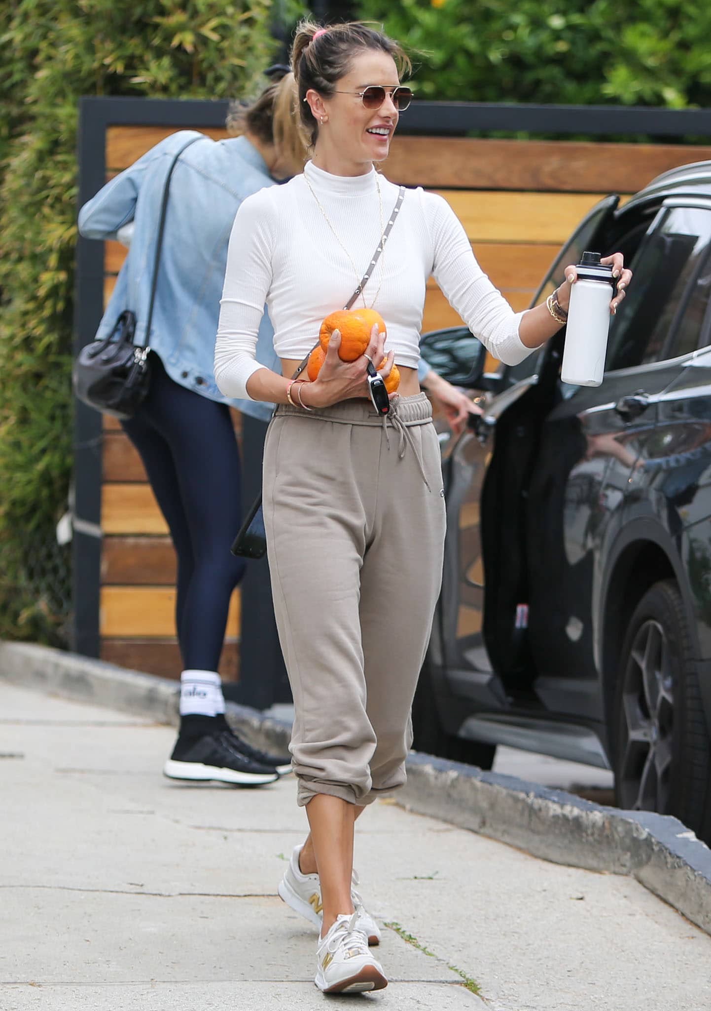 Alessandra Ambrosio leaves Pilates class in Alo Yoga white cropped sweater and Alo Yoga taupe sweatpants on April 22, 2021