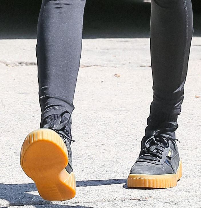 Cara Delevingne completes her sportswear with Puma black-and-gold sneakers