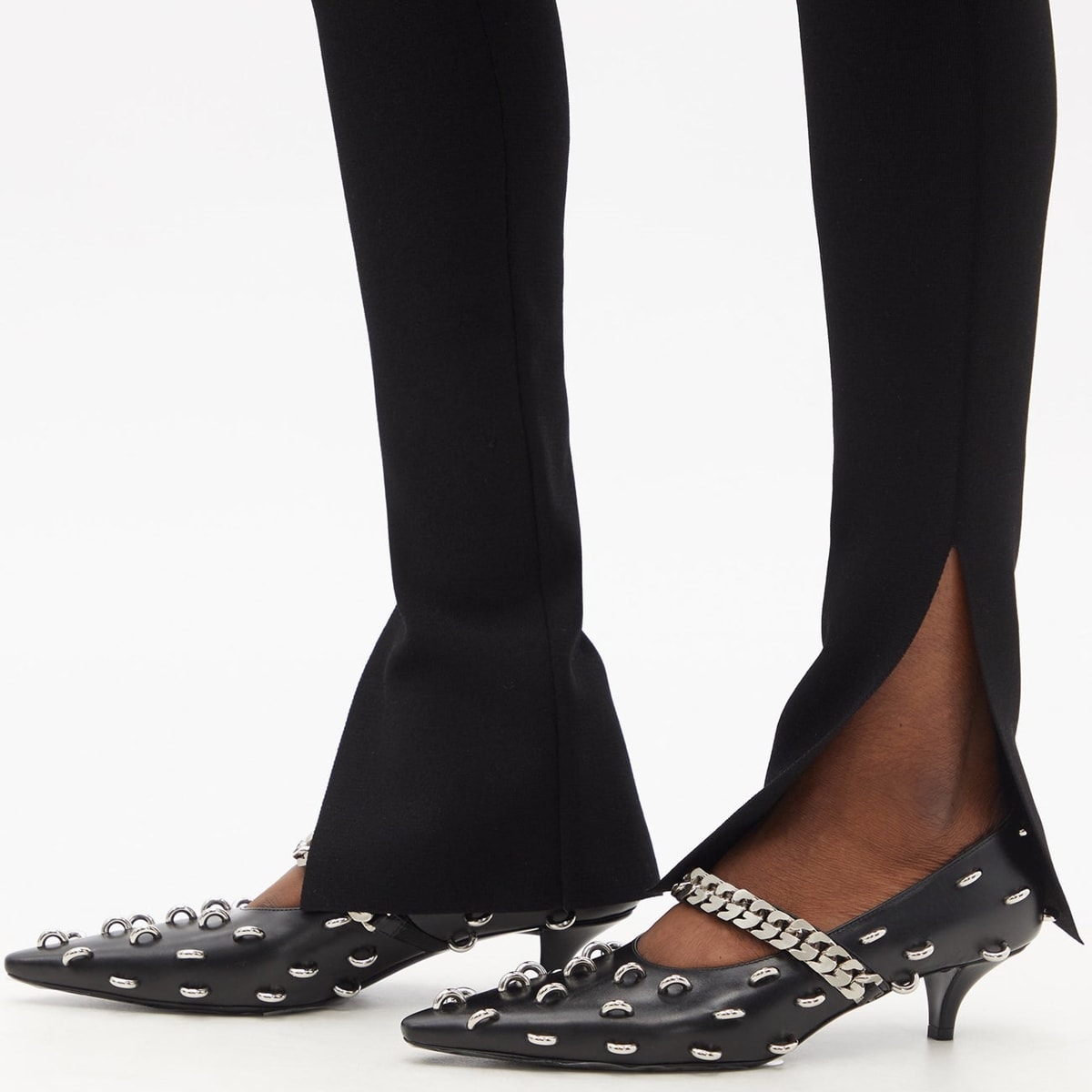 Black kitten heel pumps from Givenchy’s Matthew M. Williams embellished with studded rings across the upper