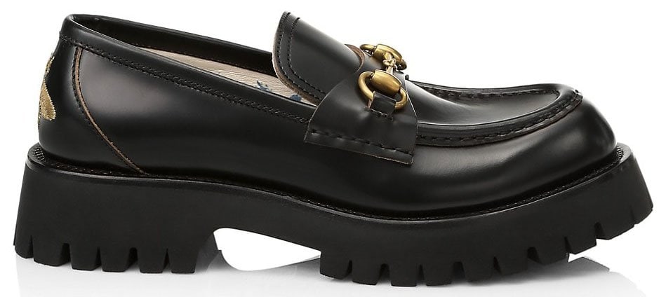 Black leather lug sole loafers with Gucci's distinctive Horsebit motif