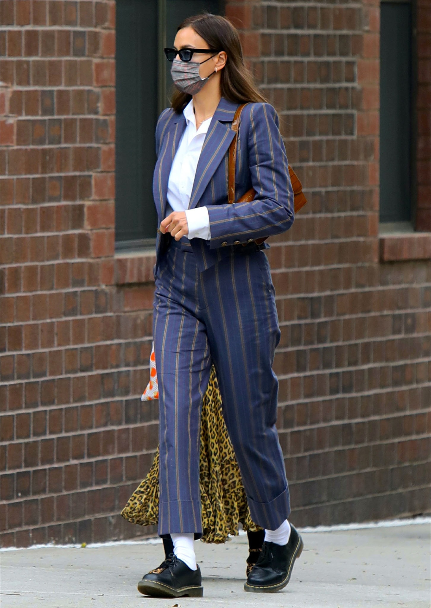 Irina Shayk looks polished in Vivienne Westwood striped suit with crisp white shirt underneath