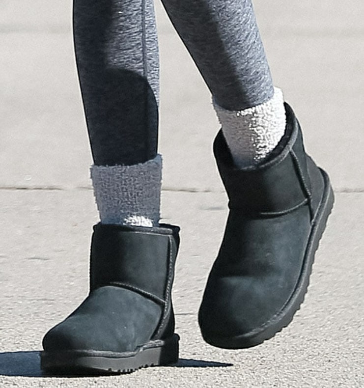 Kaia Gerber wears fuzzy gray socks with UGG Ultra Mini Classic boots