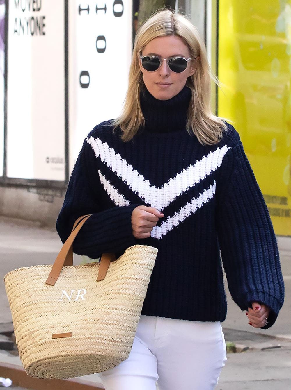 Nicky Hilton hides her eyes behind a pair of Garrett Leight sunglasses and carries a custom large basket woven tote