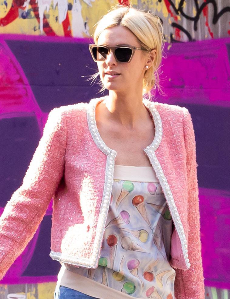 Nicky Hilton wears a low bun hairstyle and hides her blue eyes behind Illesteva sunglasses