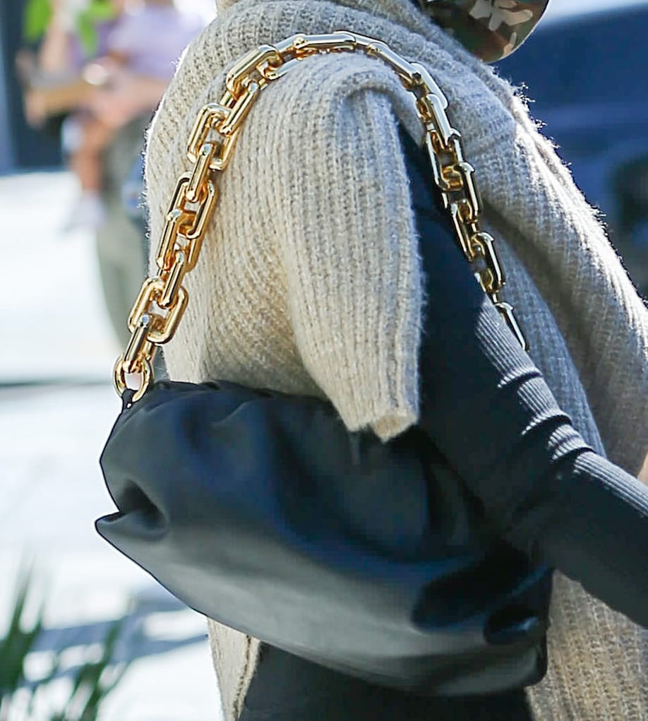 Olivia Culpo carries her essentials in Bottega Veneta The Pouch chain clutch