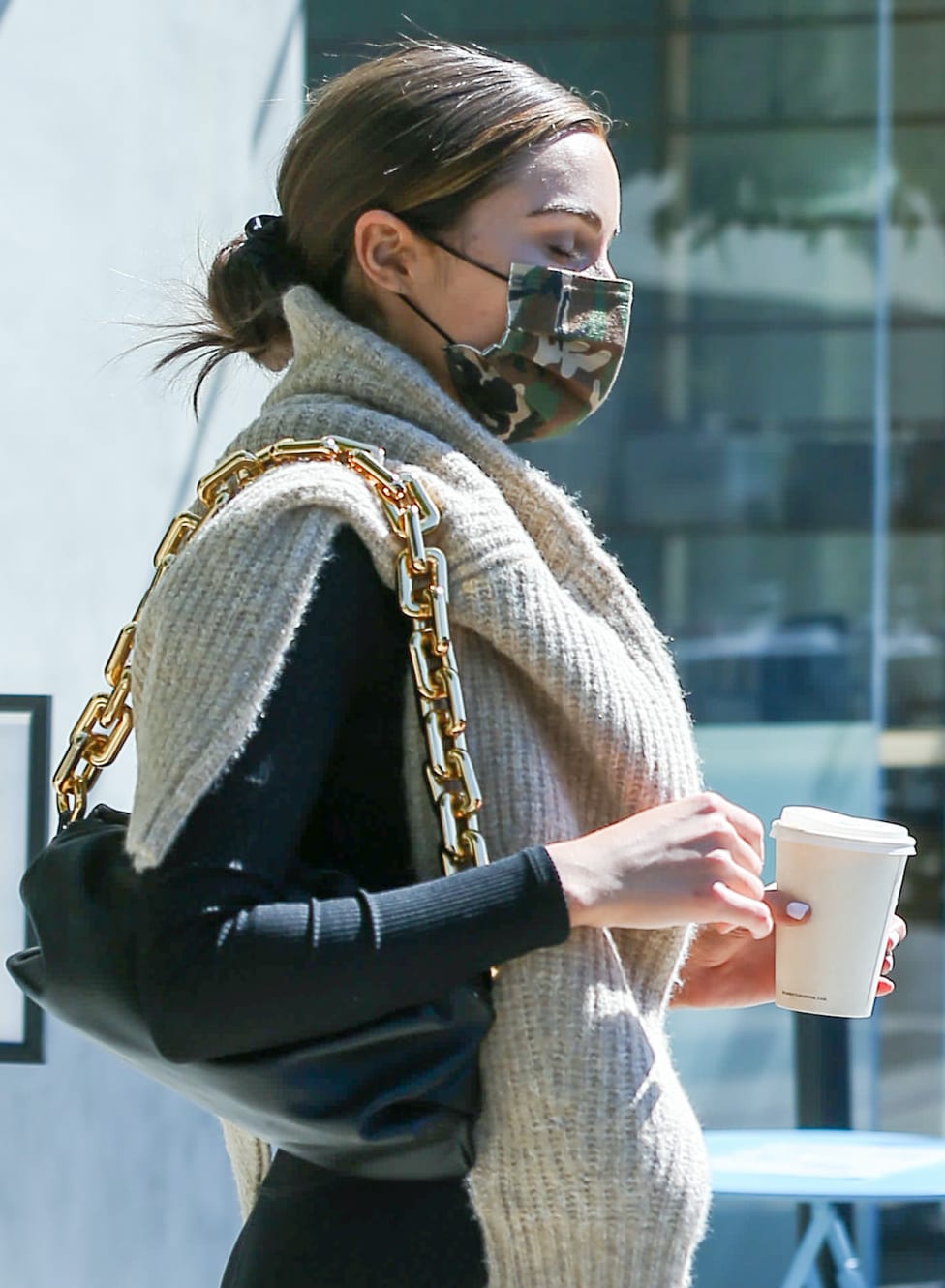 Olivia Culpo wears a camo face mask from her Together collection with Express