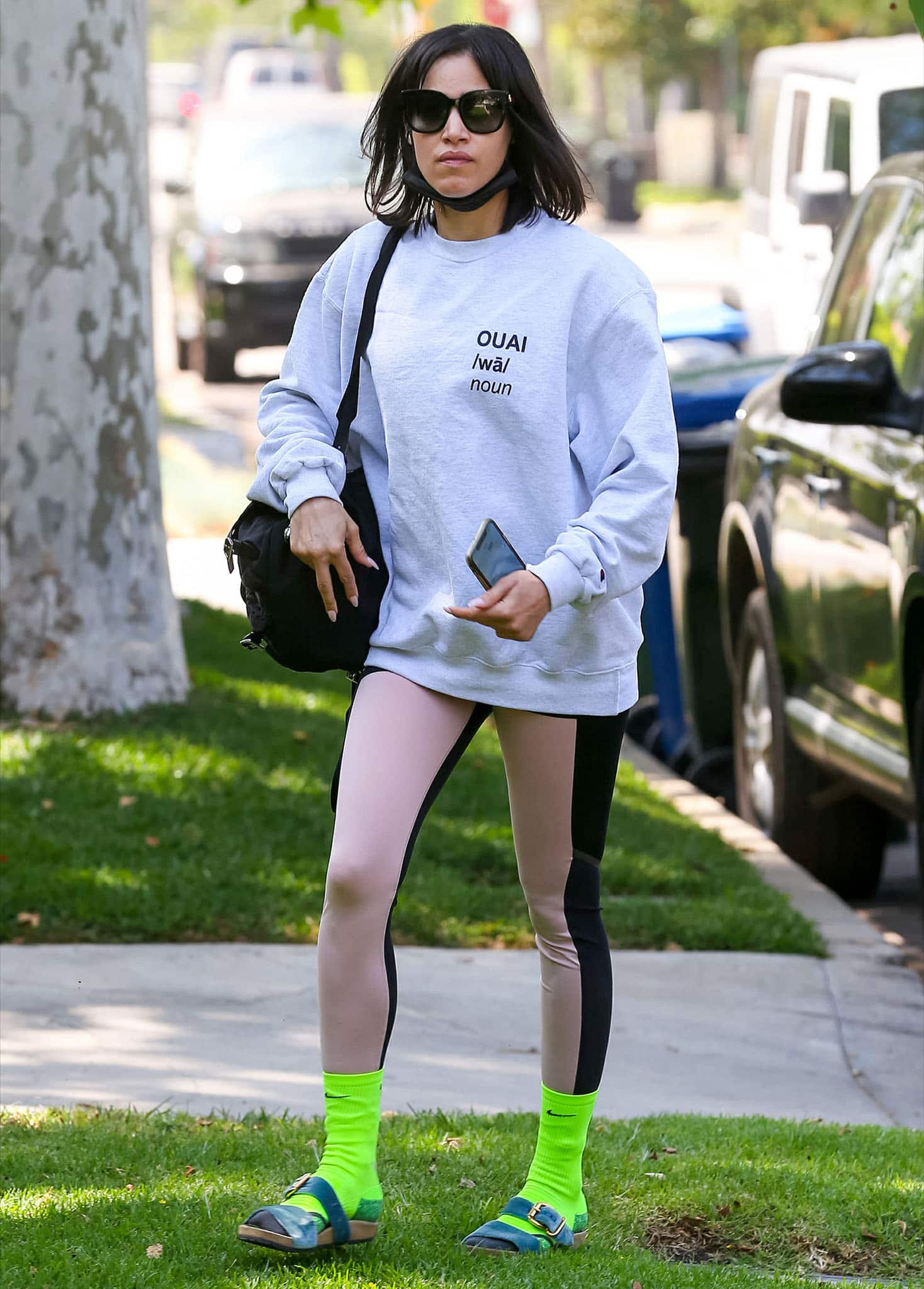 Sofia Boutella works out in a gray sweater with two-tone leggings and neon green socks on May 5, 2021
