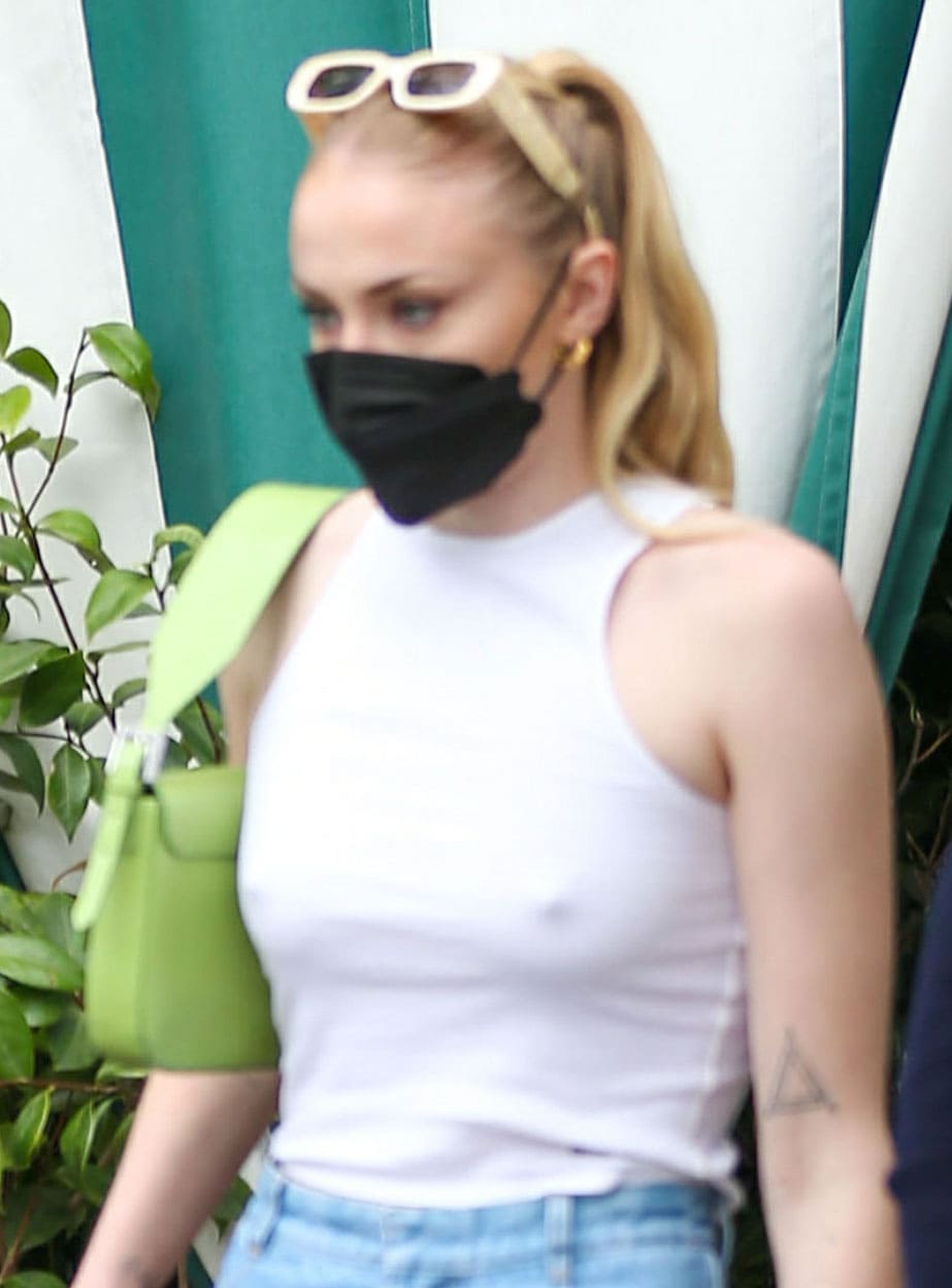 Sophie Turner looks pretty with a wavy ponytail styled with Reality Eyewear x Posse sunnies resting atop her head
