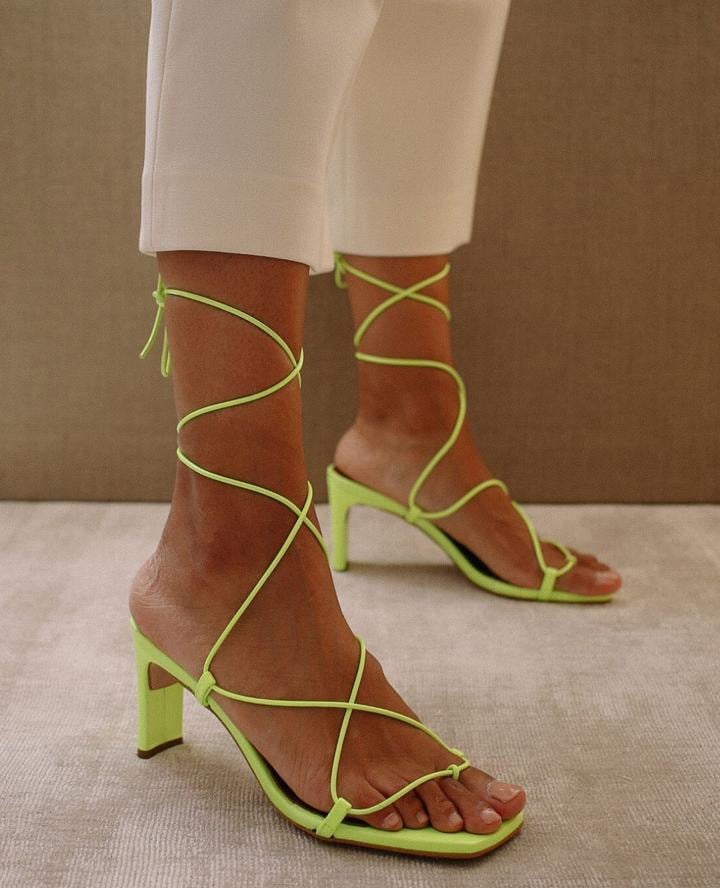 Inspired by a classic feminine silhouette, Alohas' Bellini neon green heels feature a wraparound lace-up style